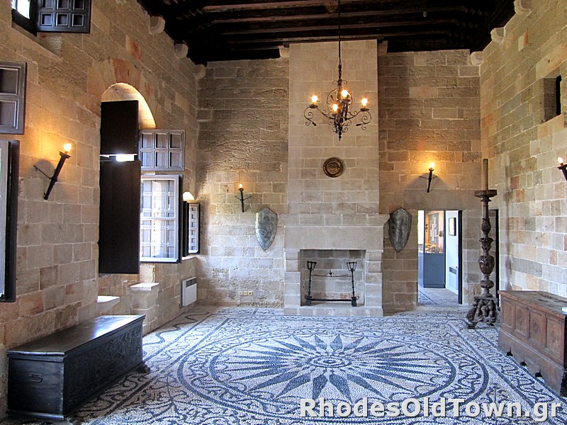 Salon avec cheminée, sol en mosaïque et décoration médiévale